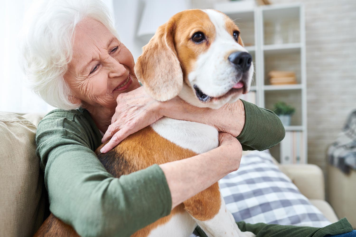 retired lady hugging her dog